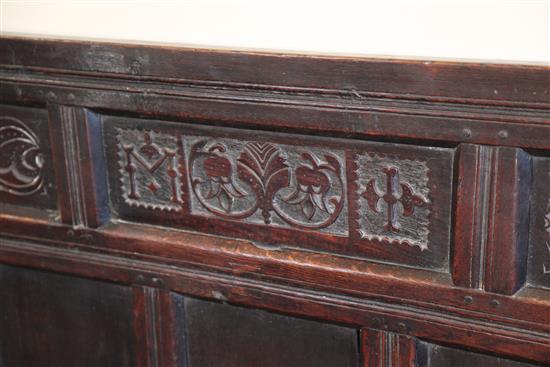 An 18th century oak settle, W.5ft 11in. D.1ft 9.5in. H.3ft 7in.